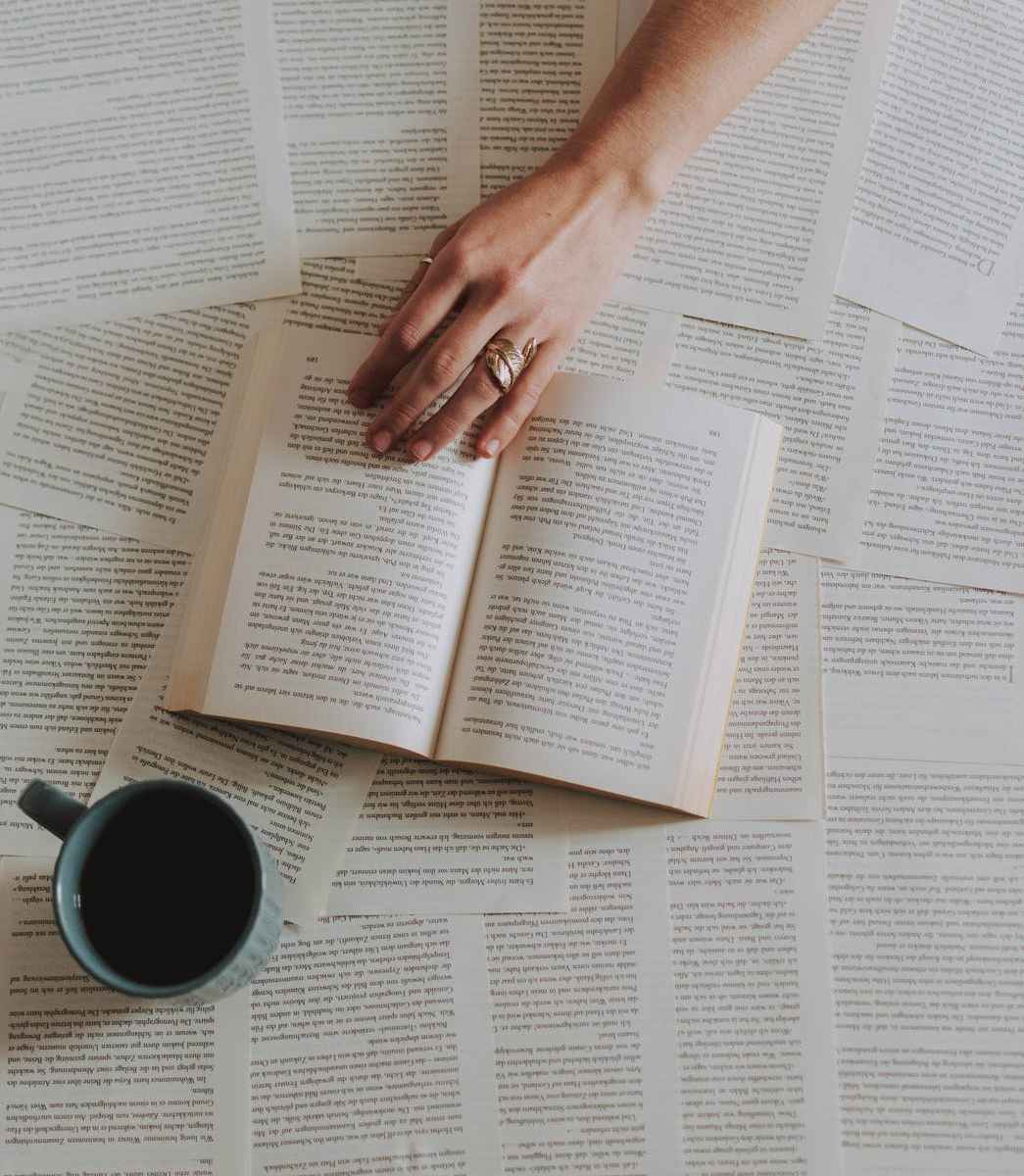 flat lay photography of an open book beside coffee mug